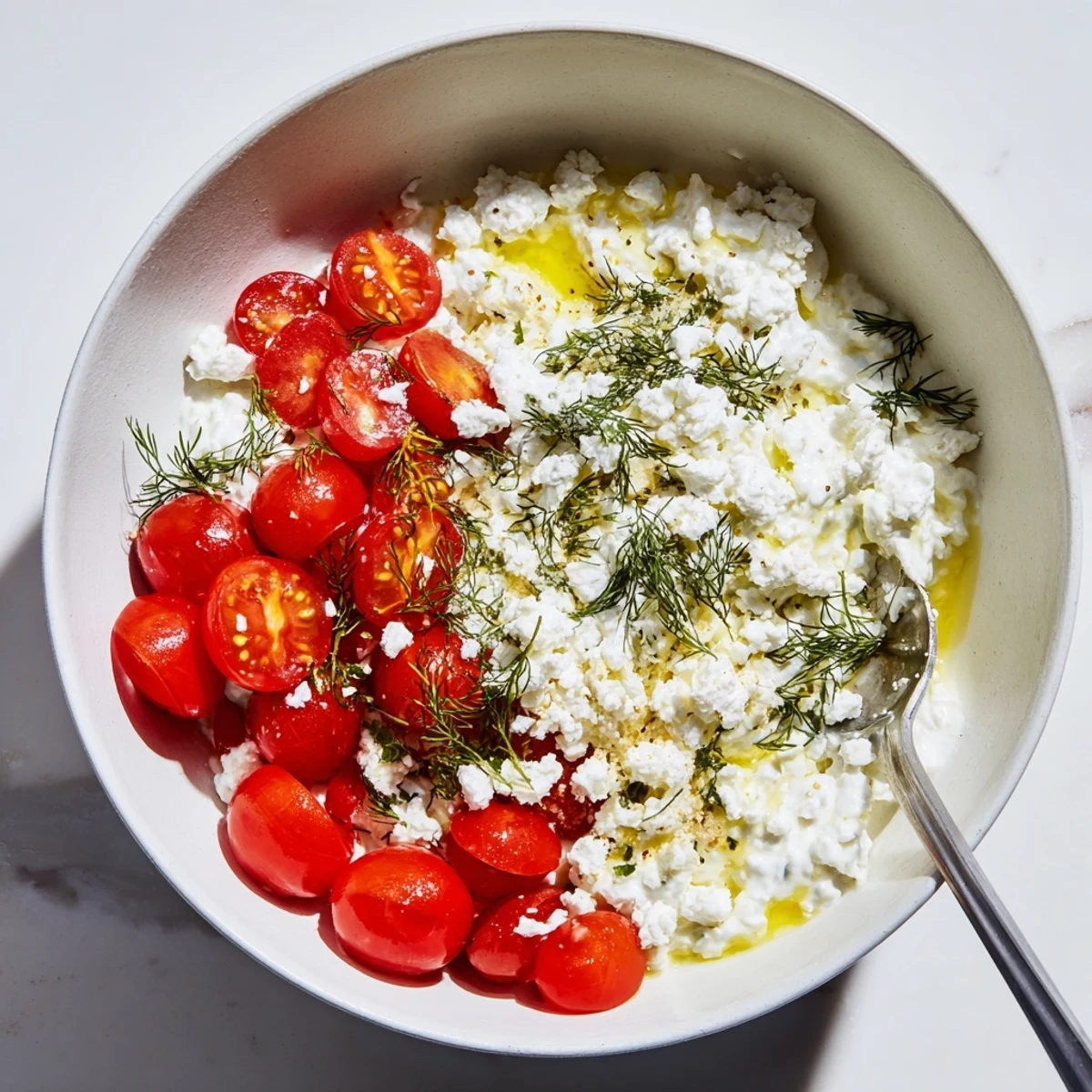 Creamy Savory Garlic & Feta Yogurt Bowl topped with fresh cherry tomatoes and dill.  