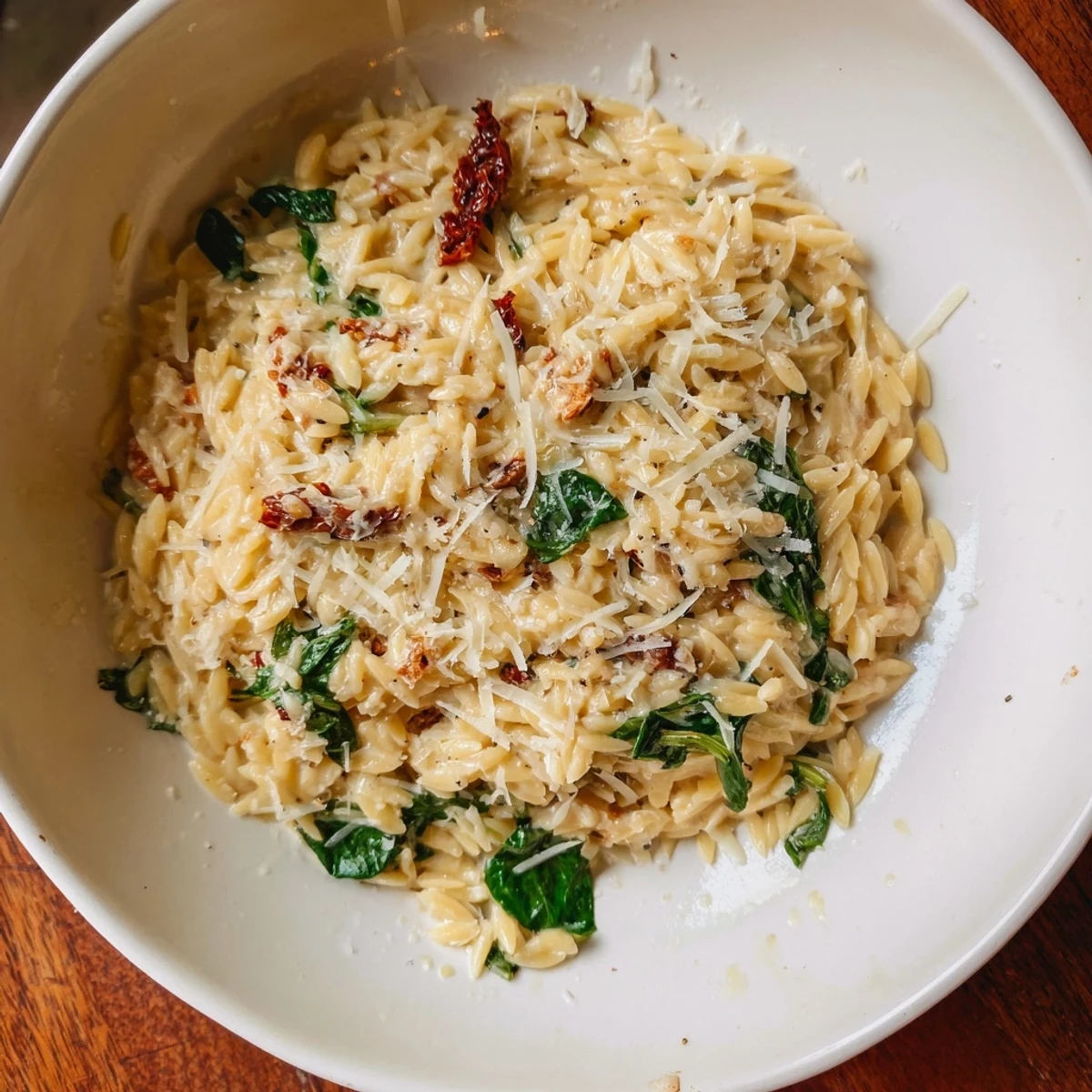 Enjoy a warm and comforting bowl of creamy Tuscan orzo; a delicious vegetarian Italian meal.