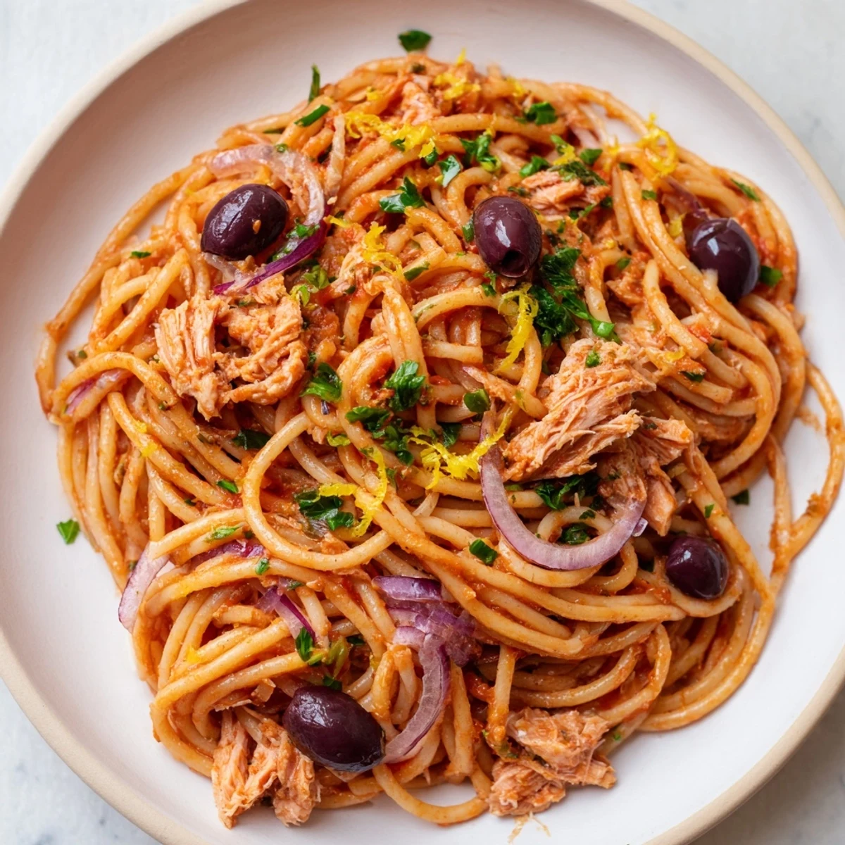 Pasta with Tuna, Olives & Capers: A plate of the vibrant Italian pasta recipe, garnished with parsley.