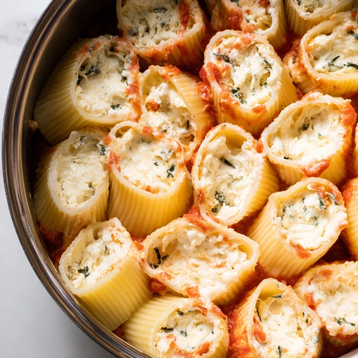 Upright rigatoni tubes in a Honeycomb Pasta Bake, filled with creamy cheese and rich marinara.