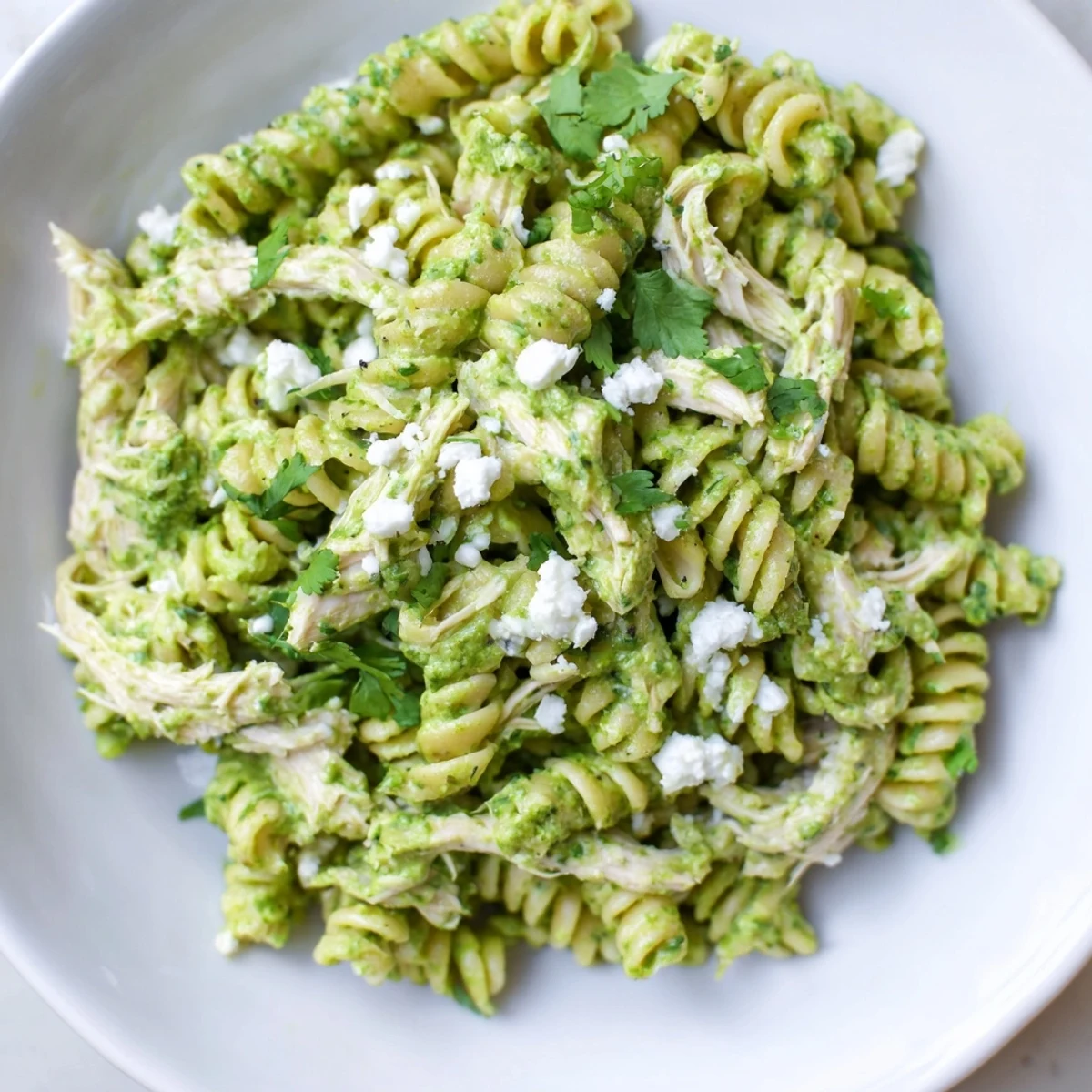 Bright lime wedges and fresh cilantro top steaming bowls of Cilantro Lime Chicken Pasta for an easy weeknight dinner.