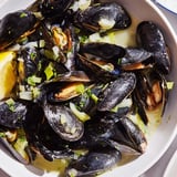 Delicious Belgian Moules Marinière, ready to serve in bowls, brimming with briny, flavorful broth.