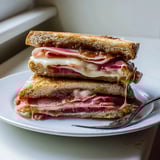 A warm, delicious Crispy Prosciutto & Fig Panini; savory and sweet flavors combined perfectly.