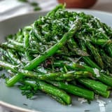 Fresh celery salad with lemon zest and Parmesan shavings, tossed in a bright olive oil dressing for a refreshing crunch.