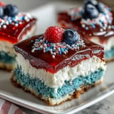 A vibrant Patriotic Poke Cake finished with fluffy whipped topping, ready for July 4th.