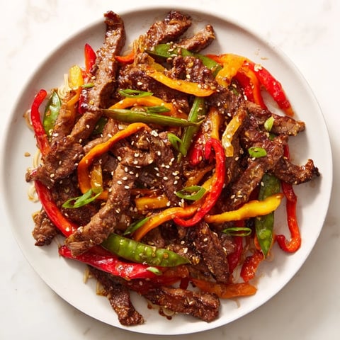 A flavorful Teriyaki Beef & Noodle Bowl showcasing tender beef and vibrant vegetables in glossy sauce.
