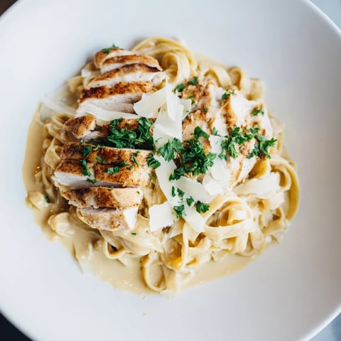 Creamy Spicy Cajun Chicken Alfredo over fettuccine, a flavorful, satisfying pasta dinner at its finest.