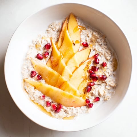 Creamy Overnight Oats with persimmon, pomegranate, and chia seeds, a colorful morning meal.