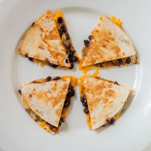 Golden, cheesy Bean & Cheese Quesadillas, with melted cheddar and a crispy tortilla shell, ready to eat.