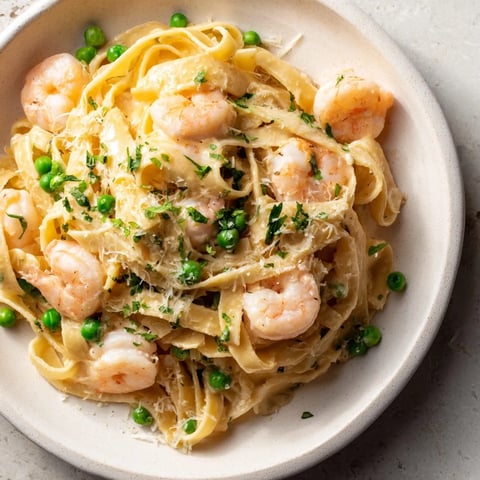 Steaming Instant Pot Shrimp Alfredo Pasta, a comforting weeknight meal with creamy sauce and shrimp.