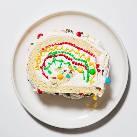 Festive Ugly Sweater Cake Roll showing colorful frosting details and sprinkles on a delicious dessert.