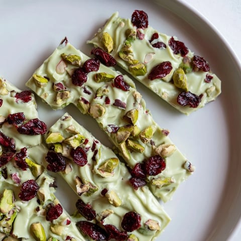 Matcha White Chocolate Cranberry Bark Clusters, a vibrant treat with visible specks of red cranberries and green matcha.