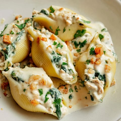 Plate of High-Protein Cottage Cheese Alfredo Christmas Shells, bubbly with melted cheese, promising a savory bite.