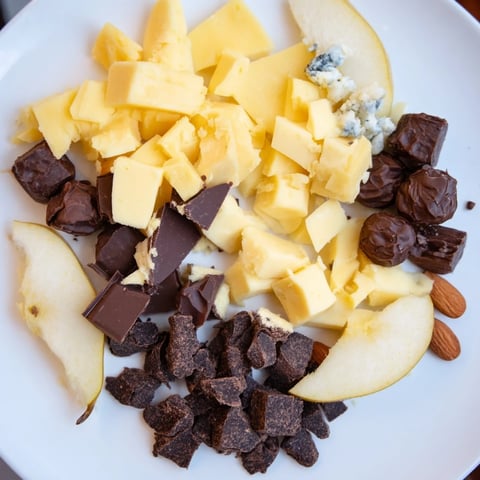 Fireside Comfort & Cocoa platter beautifully displays cheeses, chocolates, fruits, and nuts alongside hot cocoa mugs.