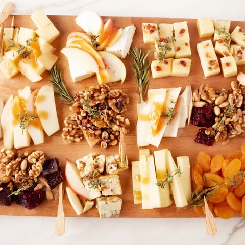 Arranged in twelve segments, this festive Twelve Days of Cheese Board offers a diverse array of cheeses.