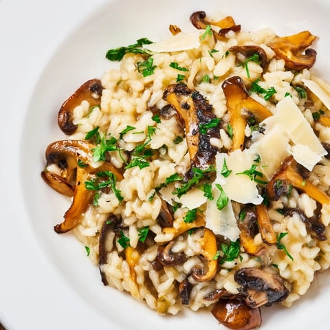 Steaming Italian Mushroom Risotto, creamy and rich, topped with fresh parsley and Parmesan.
