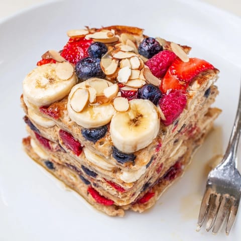 Warm, sweet Protein Berry Banana Pancake Bake with berries bursting, a delightful breakfast.