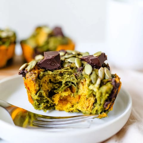 Moist vegan matcha pumpkin muffins erupt with vibrant colors, perfect for snack time.  