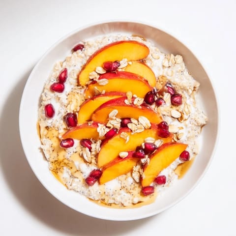 Vibrant image of Overnight Oats: sweet persimmon, red pomegranate, and chia seeds atop a cold breakfast.