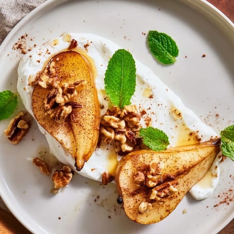Golden-brown roasted pears, perfectly soft, topped with crunchy walnuts and creamy Greek yogurt.