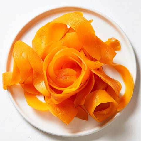 Vivid image of The Copper Coil appetizer with alternating cheddar ribbons and sliced dried apricots for guests.