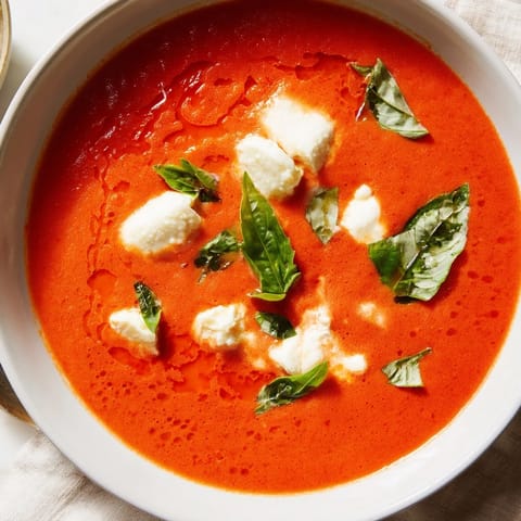 Warm and comforting creamy tomato mozzarella soup, perfect for cold days with melted cheese.
