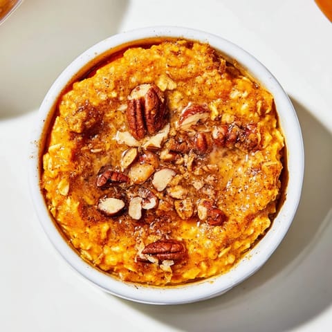 A close-up shot of fluffy Pumpkin Spice Baked Oats, showcasing the cozy autumn spices and texture.