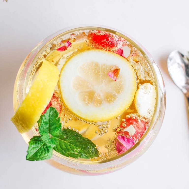 Tangy-sweet kombucha mocktails bubbling with ginger and lime flavors served chilled.  