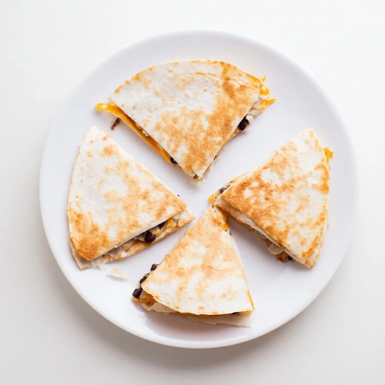 Warm, melty cheese and black bean filling oozes from these easy homemade Bean & Cheese Quesadillas, ready to serve!