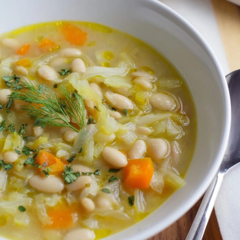 Close-up of a rustic Simple White Bean and Fennel Soup, showcasing the creamy texture and aromatic flavors.