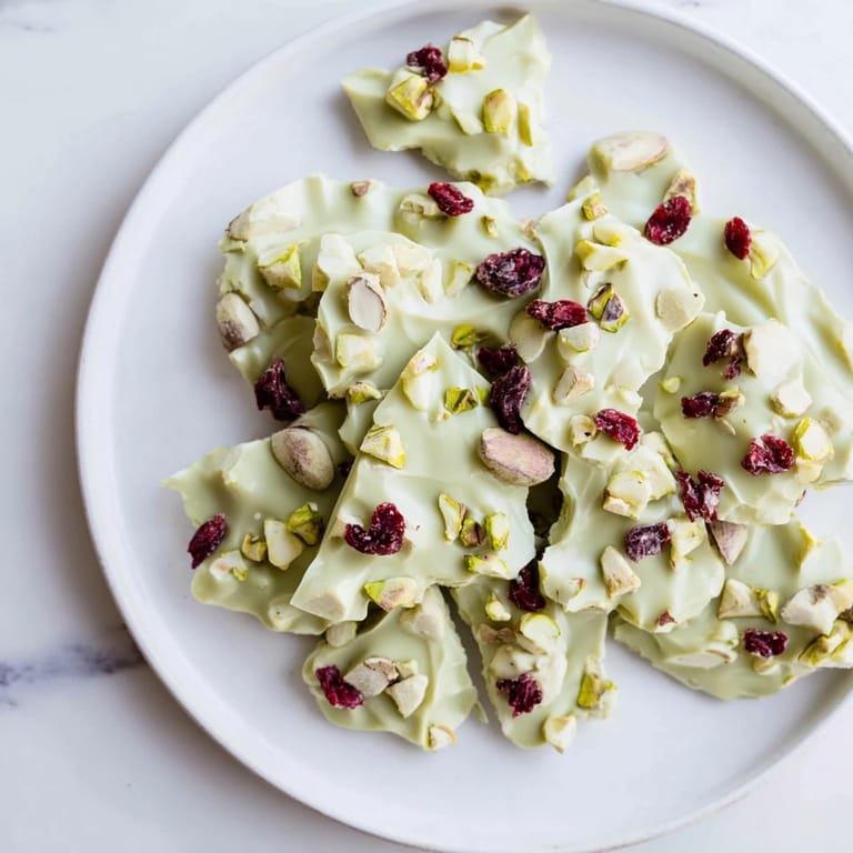 Enjoy these Matcha White Chocolate Cranberry Bark Clusters; they feature a delicate texture perfect for a sweet, quick dessert.