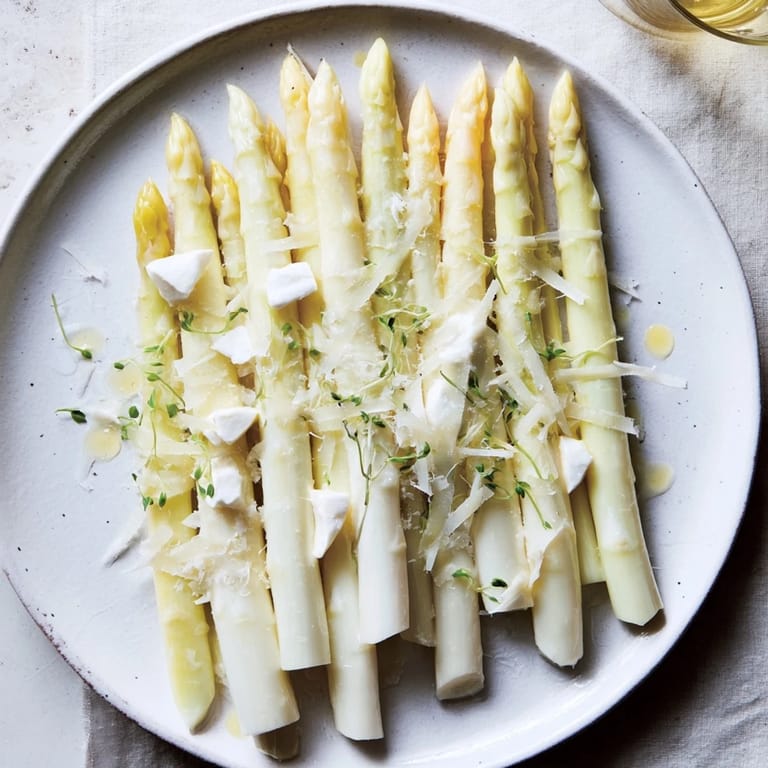 A vibrant photo of The Silver Birch: delicate asparagus and cheeses, drizzled with lemon vinaigrette and truffle.