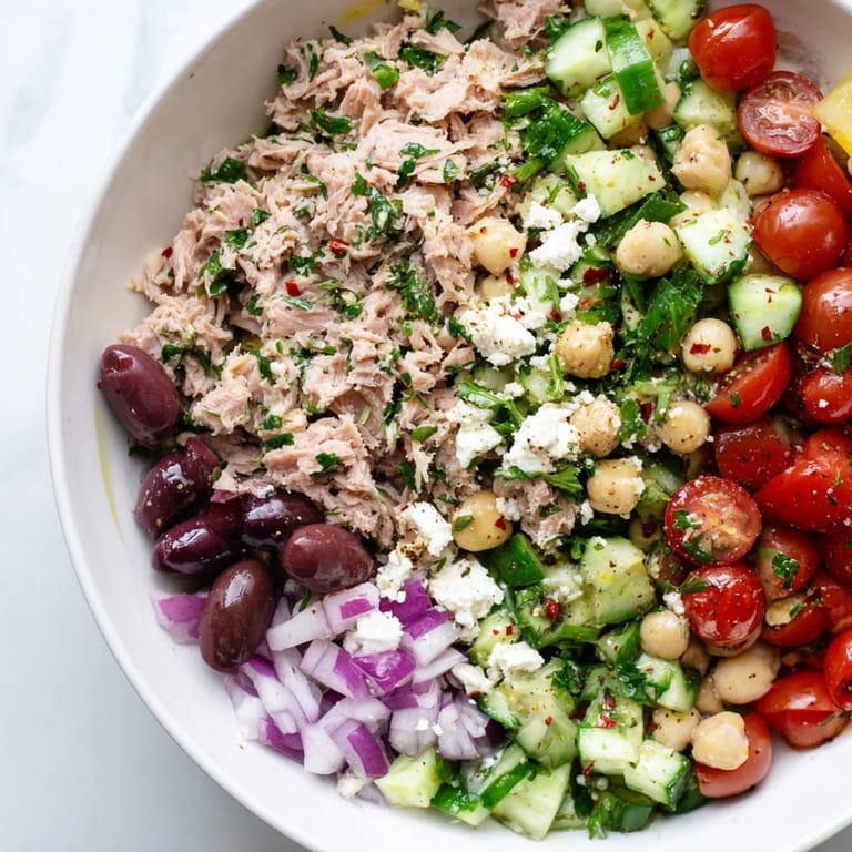 A delicious bowl of Tuna Chickpea Salad with olives, and parsley; perfect for lunch!