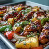 Vibrant chicken pineapple sheet pan fajitas with colorful bell peppers, onions, and juicy pineapple chunks roasted to perfection.