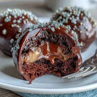 Festive Pot of Gold Cake Pops with black coating and golden sprinkle coins, perfect for St. Patrick's Day celebrations.
